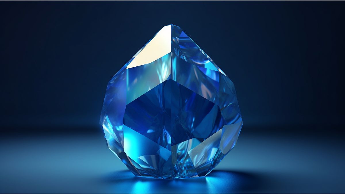 Farbedelsteine: Ein blauer Edelstein vor einem dunklen Hintergrund.